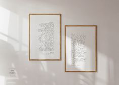 two framed photographs hanging on the wall next to each other with writing in gold frames