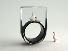 "SO CUTE, THAT YOU GET GOOSE BUMPS... A wonderful, handmade unique for all friends of poultry. On a black ring stands the white goose Martin and quacks. Next to him sits Gustav and listens. The ring is very light and despite of the size extremely good to wear. Moreover it is a hand charmer and always an eye-catcher. SIZE/DIMENSIONS/WEIGHT This ring will be produced suitable for you (I need about three weeks for the production). Please specify your ring size (you can measure the inner diameter of Goose Bumps, Resin Jewelry Diy, White Goose, Transparent Resin, Black Ring, Ring Stand, All Friends, Polymer Clay Crafts, Party Night