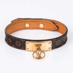 A beautiful piece of statement jewellery from Louis Vuitton. A classic monogram canvas print leather bracelet. Decorated with a signature golden plaque and a hanging LV circle charm. This little accessory is such a charmer. Wear this bracelet along with your Louis Vuitton handbag and the new Louis Vuitton ankle boots. SPL Exterior Monogram canvas Leather lining Brass with gold finishing LV logo in circle Adjustable fastening according to your wrist size A few scratches on the golden plaque Some wear to the monogram canvas Comes with dust bag and box SPL Length: 22 cm Logo In Circle, Louis Vuitton Ankle Boots, Lv Logo, Classic Monogram, Louis Vuitton Handbag, Statement Jewellery, Vuitton Handbags, Dior Shoes, Timeless Handbag