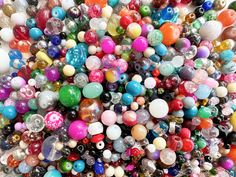 many different colored beads are grouped together