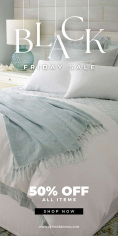 black friday sale with white bedding and blue pillows on the bed in front of it