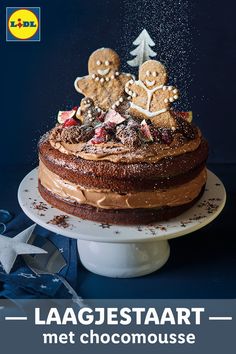 a cake with chocolate frosting and sprinkles on top is shown in front of a blue background