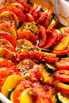 a dish with tomatoes and zucchini in it