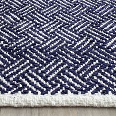 a blue and white rug on the floor