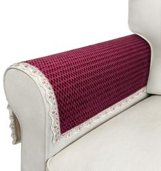 the back of a white chair with a red and white cushion on top of it