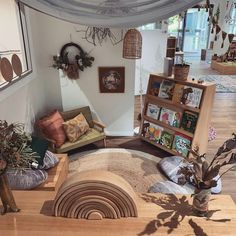 a living room filled with lots of furniture and decor on top of a wooden floor