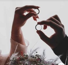 two people holding rings in their hands