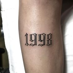 a person with a tattoo on their leg that says,'999'in black ink