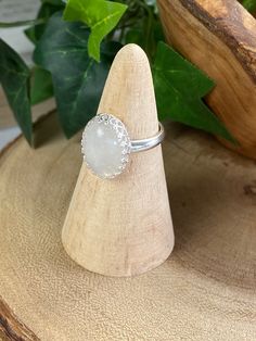 This cool, white Rainbow Moonstone gemstone ring reminds me of the puffy clouds that accent a Spring day. After a rain you can see the dark clouds turn to wisps of white with a faint rainbow glistening through. This stone is just that! As you look at the ring and turn it you will see subtle flashes of blue purple and maybe green. The lovely way the stone is nestled within the Sterling silver scalloped bezel setting gives this special piece a dainty yet bold look and feel. Designed in a timeless White Moonstone Ring Gift, White Moonstone Gift Ring With Round Stone, White Adjustable Moonstone Ring As Gift, Adjustable White Moonstone Ring As Gift, White Moonstone Cabochon Promise Ring, White Moonstone Round Ring, Adjustable Oval White Moonstone Ring, Adjustable White Oval Moonstone Ring, White Moonstone Rings As A Gift