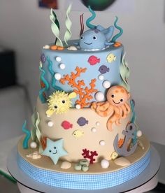 a three tiered cake decorated with under the sea theme