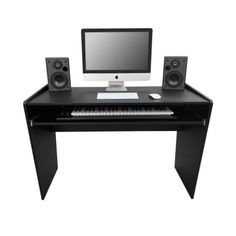 a computer desk with speakers and a monitor on it's stand up keyboard,