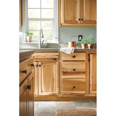 a kitchen with wooden cabinets and white walls