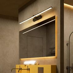 a bathroom with a yellow sink under a mirror and lights on the wall above it