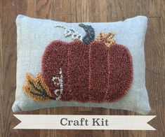 a pillow with a pumpkin on it and the words craft kit written in front of it