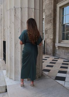 PRODUCT DETAILS: Satin midi dress in dark green Short sleeve Waist tie Functional buttons True to size Minimal stretch Length: 55" 95% Polyester, 5% Spandex Model 1 is wearing a Small Model 1 Info: Height: 5'3", Bust: 36 3/4". Waist: 30", Hips: 38.5" Model 2 is wearing a size Medium Model 2 Info: Height: 5'6", Bust: 41", Waist: 34, Hips: 41" Ruched Maxi Dress For Work, Fitted V-neck Midi Dress In Dark Green, Fitted Dark Green Midi Dress With V-neck, Fitted Dark Green V-neck Midi Dress, Formal Green Ruched Midi Dress, Office Midi Dress With Ruched Detail, Green Stretch Midi Dress For Work, Green Midi Dress For Work, Green Belted Midi Dress For Work