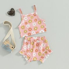 Welcome your little one to warm weather in this delightful FLOWER POWER Crop Top Summer Outfit! With its soft floral sleeveless crop top, perfectly paired with matching shorts in either pastel pink or pastel blue, your baby girl will look positively posh! Brighten up any sunny day with this one of a kind outfit. Summer never looked (or felt) so good! Summer Floral Print Pink Set, Pink Matching Set Tops For Summer, Pink Floral Print Playwear Sets, Pink Floral Print Sets For Playwear, Pink Sleeveless Matching Set Top, Pink Sleeveless Top Matching Set, Playful Pink Sleeveless Set, Cute Pink Sleeveless Clothing Sets, Cute Pink Sleeveless Sets