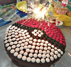 a chocolate cake with white and red frosting has sparklers in the shape of a flag