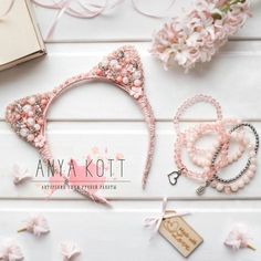 pink headbands, bracelets and necklaces laid out on a white table