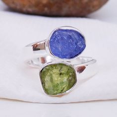 Natural Raw Tanzanite & Peridot Ring, Multi Stone Ring, Adjustable Ring, Handmade Silver gemstone Ring. Product:- Ring Modal no:- U379 Metal:- 925 Sterling Silver Gemstone :- Peridot & Tanzanite Gemstone size:- 8x10 mm approx. Finishing:- Shiny Silver We are using Pure 925 (Stamped) Sterling Silver with Natural Gemstone Jewelry, all of our jewelry designs are Handmade. We are adding new creative designs in our store regularly, for new handmade stuff please get touch with our store. We al Handmade Peridot Rings As Gift, Handmade Peridot Rings For Gift, Peridot Open Ring Jewelry Gift, Peridot Open Ring Jewelry For Gifts, Adjustable Round Peridot Ring, Adjustable Green Round Birthstone Ring, Adjustable Peridot Ring, Green Birthstone Rings For Jewelry Making, Unique Adjustable Green Stackable Rings