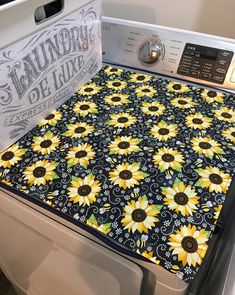 the sunflowers are on top of the washer and it is ready to be washed