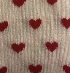 red hearts are arranged on white knit fabric