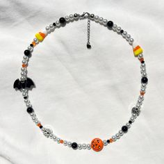 get spooky with this halloween necklace! 👻 ❥ bead assortment: white glass pearls, black acrylic bat, lampwork glass candy corn, silver metal skulls, mini glass crystals, & a dyed howlite jack o' lantern  ❥ length: 16, 18, or 20 inches + extension chain with heart tag ❥ necklace findings: gold or silver plated stainless steel & tarnish resistant ⊹ ₊ 🕸 🕷 🕸 ₊ ⊹⊹ ₊ 🕸 🕷 🕸 ₊ ⊹⊹ ₊ 🕸 🕷  ʚ♡⃛ɞ jewelry care tips ʚ♡⃛ɞ ❥ don't leave your beaded jewelry sitting in the sun ❥ avoid excessive stretching Spooky White Halloween Jewelry, Handmade Black Beaded Necklace For Halloween, Halloween Beaded Necklace, Halloween Jewelry Diy, Halloween Beaded Jewelry, 90s Jewelry, Metal Skull, Halloween Beads, Halloween Necklace