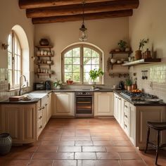 a kitchen with an arched window and tile flooring is pictured in this image, there are potted plants on the windowsill