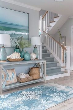 a living room filled with lots of furniture next to a stair case in front of a painting on the wall