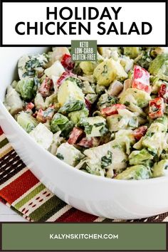 a white bowl filled with salad on top of a striped place mat and text overlay that reads holiday chicken salad