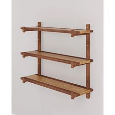 two wooden shelves are hanging on the wall