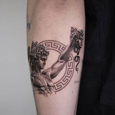 a man with a tattoo on his arm that has an image of two women holding hands