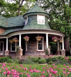 a house with flowers in the front yard