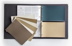 an open book with several different colors of paper