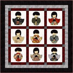 a quilted wall hanging with nine dolls on it's sides, all in black and white