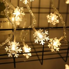 snowflake lights are hanging from a wire