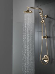 a shower head with thermostaer and hand held shower faucet in gold