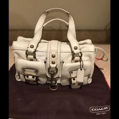 Coach Handbag With Beautiful Interior Lining And Brass Detailing On Exterior. Brand New, But Unfortunately There Are Some Small Discoloration From The Brass Detailing As Seen In Photos. Originally Paid $629 But Reduced Price Listed Due To Disclosed Markings. Designer Shoulder Bag With Branded Hardware For Errands, White Designer Bag With Top Carry Handle, White Designer Bags With Top Carry Handle, Designer Satchel With Branded Hardware, Travel Tote Bag With Branded Hardware, White Designer Handheld Satchel, Designer White Office Bag, Travel Satchel Shoulder Bag With Branded Hardware, Designer White Satchel For Errands