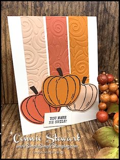 a card with some pumpkins on it next to fall leaves and acorns