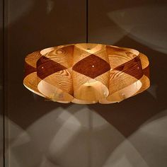 a wooden light fixture hanging from a ceiling