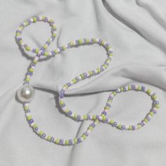 a pair of scissors and beads on a white sheet