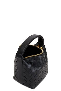 Find BOTTEGA VENETA Candy Wallace Handbag In Black on Editorialist. Bottega Veneta Candy Wallace Handbag in Black Intrecciato lambskin leather exterior with calfskin lining. Made in Italy. Top zipper closure. One main compartment. Adjustable top handle. Measures approx 7.5 W x 6 H x 4.5 D Top handle with a 4 drop. BOTT-WY1543. 776781-V3IV1-8425. About the designer: Bottega Veneta – inspiring individuality with innovative craftmanship since 1966. Creativity lies at the heart of all that we do. Bo Dream Bag, Italian Culture, Black Handbags, Lambskin Leather, Bottega Veneta, Top Handle, Calf Skin, White Gold, Candy