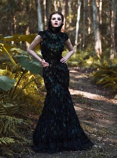 Stunning black feather mermaid dress with a dramatic high collar and 30" train. Fit for a dark queen! Hundreds of gorgeous authentic feathers were applied individually by hand to the fabric dress base to create this unique dress. Feathers were originally green and gold and dyed black. They have a glossy iridescent sheen and the rich green and gold tones can be seen in the sunlight and flash photography. Please note dyed or painted feathers may transfer traces of color or feather fluff, be careful to store in a breathable garment bag and take care to not sit on light colored furniture or anything that could get easily soiled. Feather Couture, The Raven Queen, Vampire Beauty, Raven Costume, Julia Marie, Dark Costumes, Raven Dress, High Class Fashion, Feather Gown