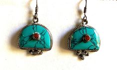 This pure silver, turquoise and coral earrings are handmade in Nepal. It is traditional Tibetan jewelry and it has double Vajra on the back. Traditional Silver Hand-strung Turquoise Necklace, Traditional Hand-tooled Turquoise Jewelry, Spiritual Turquoise Sterling Silver Earrings, Tibetan Jewelry, Turquoise Nickel-free Southwestern Earrings, Ethnic Tibetan Turquoises Earrings, Turquoise And Coral, Coral Earrings, Raleigh Nc