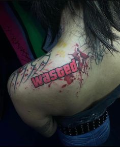 the back of a woman's shoulder with blood splattered on it that says wasted