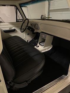 the interior of an old car with black leather seats