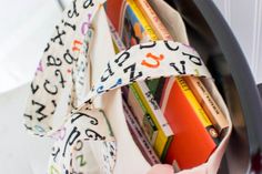 a close up of a book shelf with books and tape on the top of it