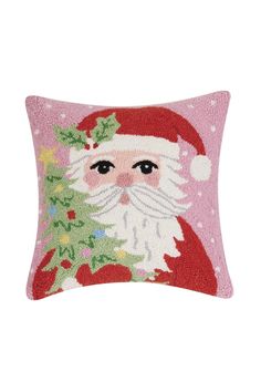 a pink pillow with santa claus on it's face and holly wreath around the neck