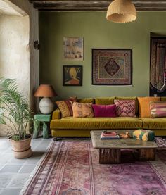 a living room filled with lots of furniture and decor on top of a carpeted floor