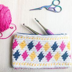 a crocheted pouch with scissors and yarn next to it