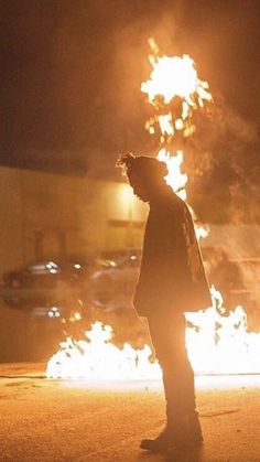 a man standing in the middle of a street with fire coming out of his mouth